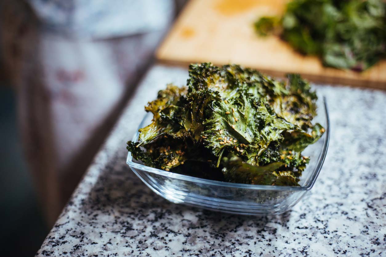 crunchy snack of kale chips in bowl on counter