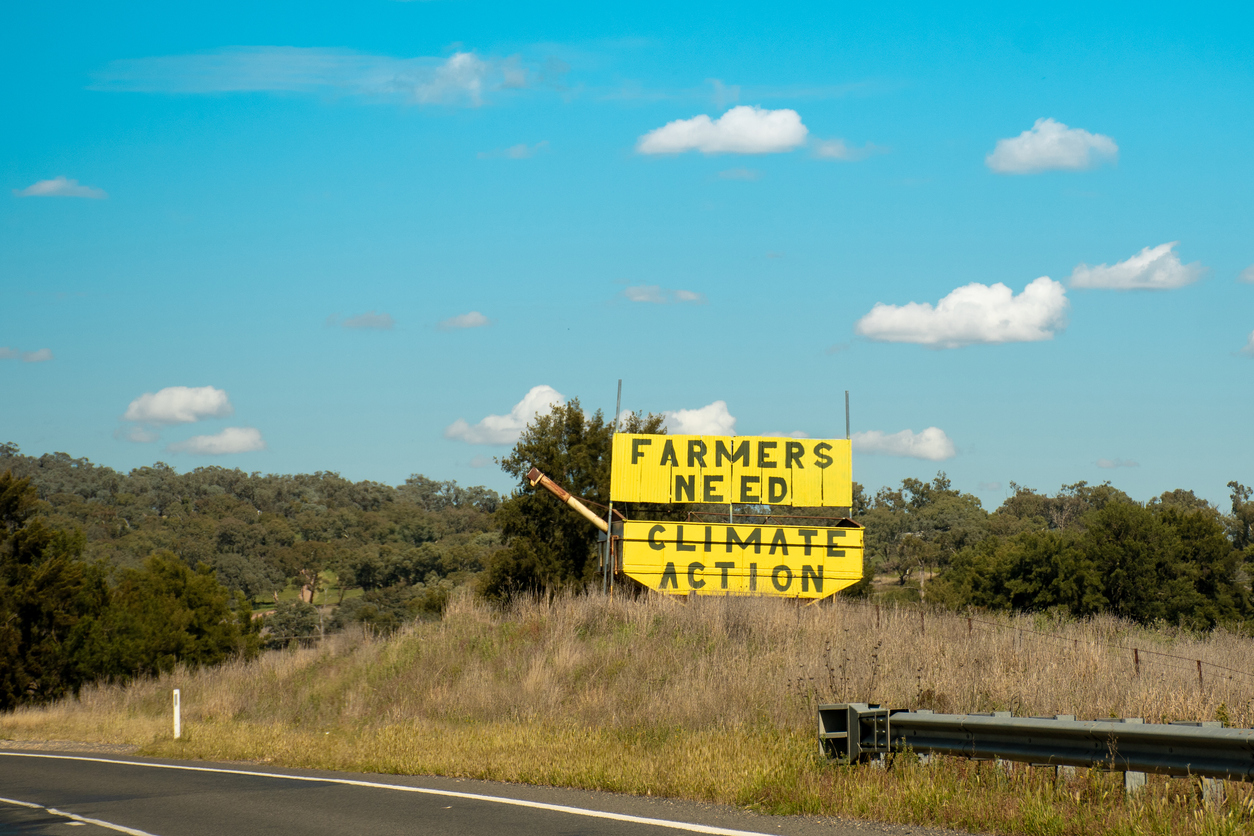 Farmers need climate action - sign on the road side in Australia. Farmers for Climate Action is a movement of more than 5000 farmers, agricultural leaders and rural Australians
