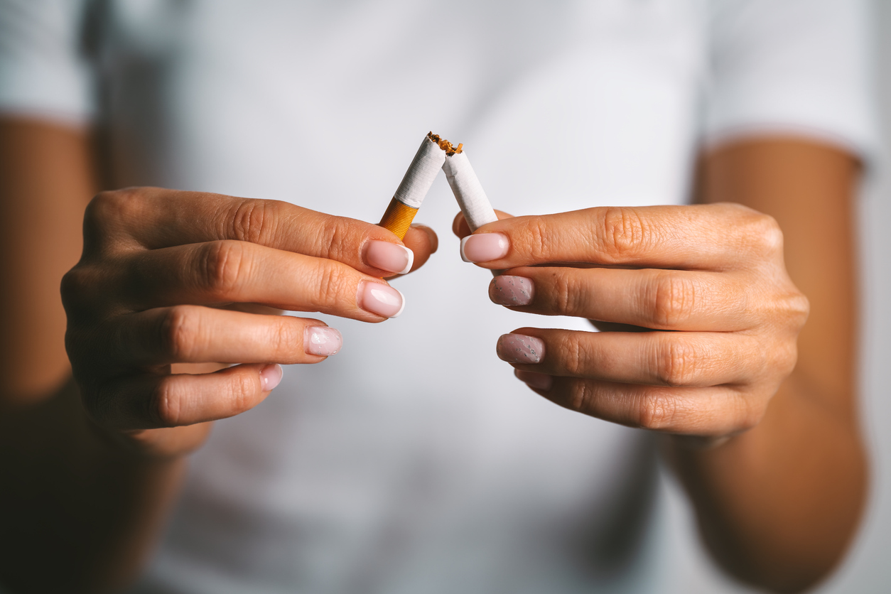 Woman brakes cigarette in hands. Woman refusing tobacco. Stop smoking, quit smoking or no smoking cigarettes. High quality photo